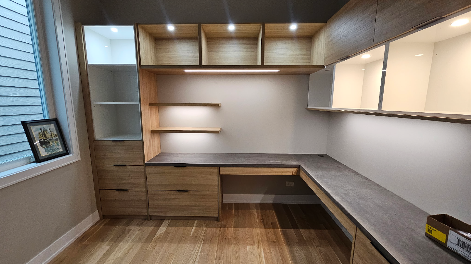 Built-in corner office desk with wood cabinetry, floating shelves and display cabinets