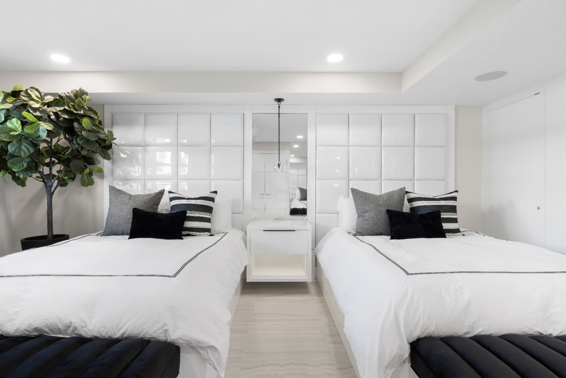 Custom bedroom with a glossy built-in headboard, floating nightstand and integrated lighting