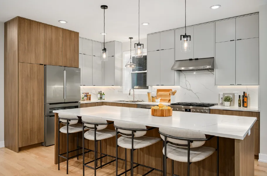 Light wood kitchen cabinetry with a white island, quartz countertops and open shelving